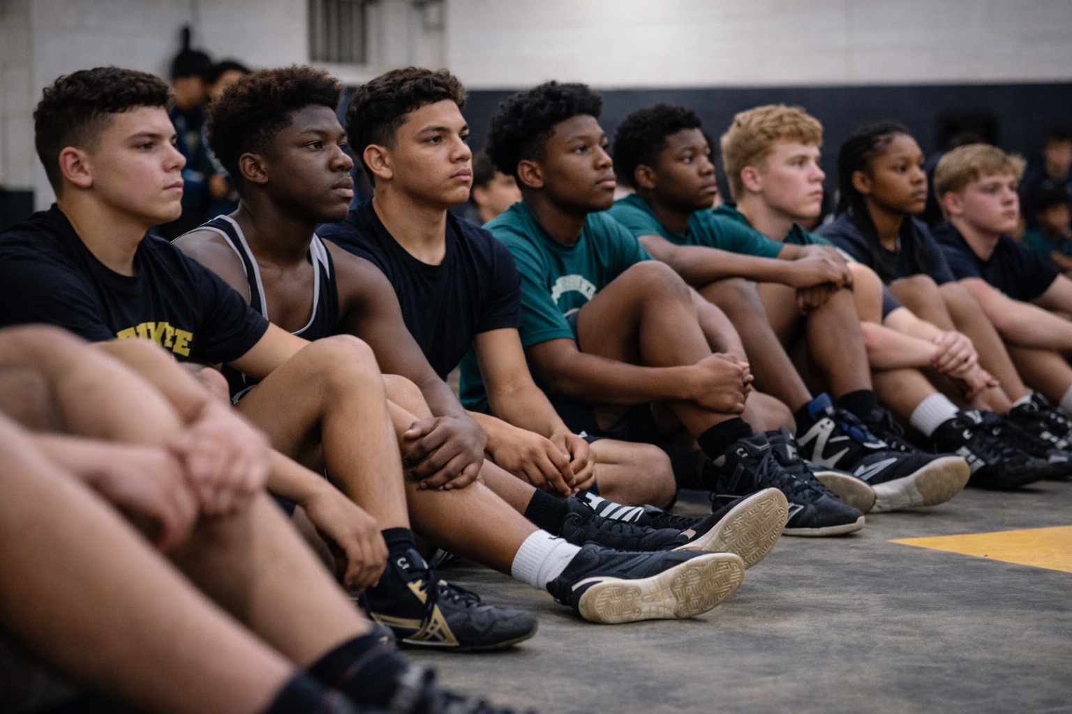 Student-athlete preparing wrestling gear